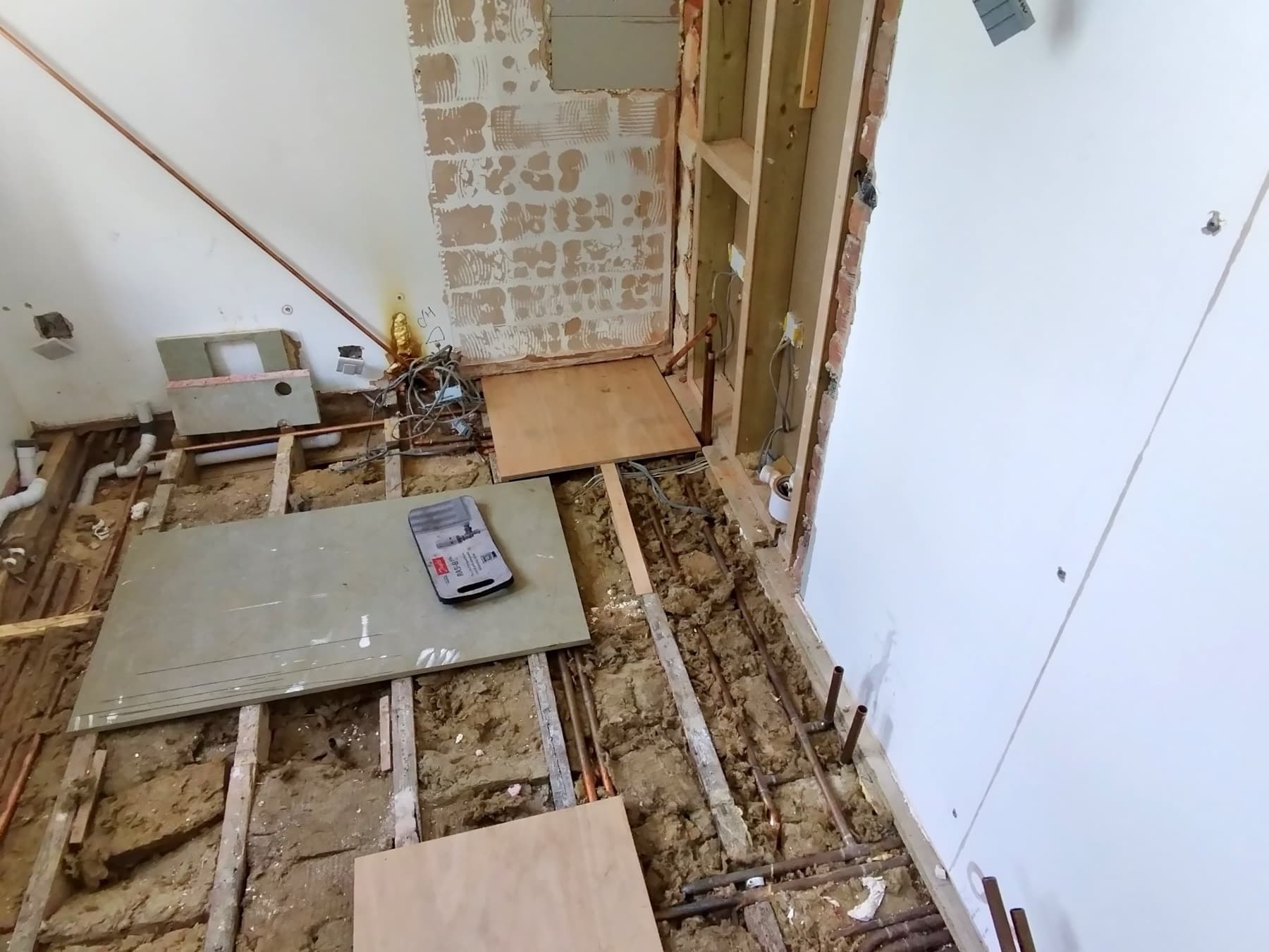 Bathroom first fix with the floorboards up and new pipework laid