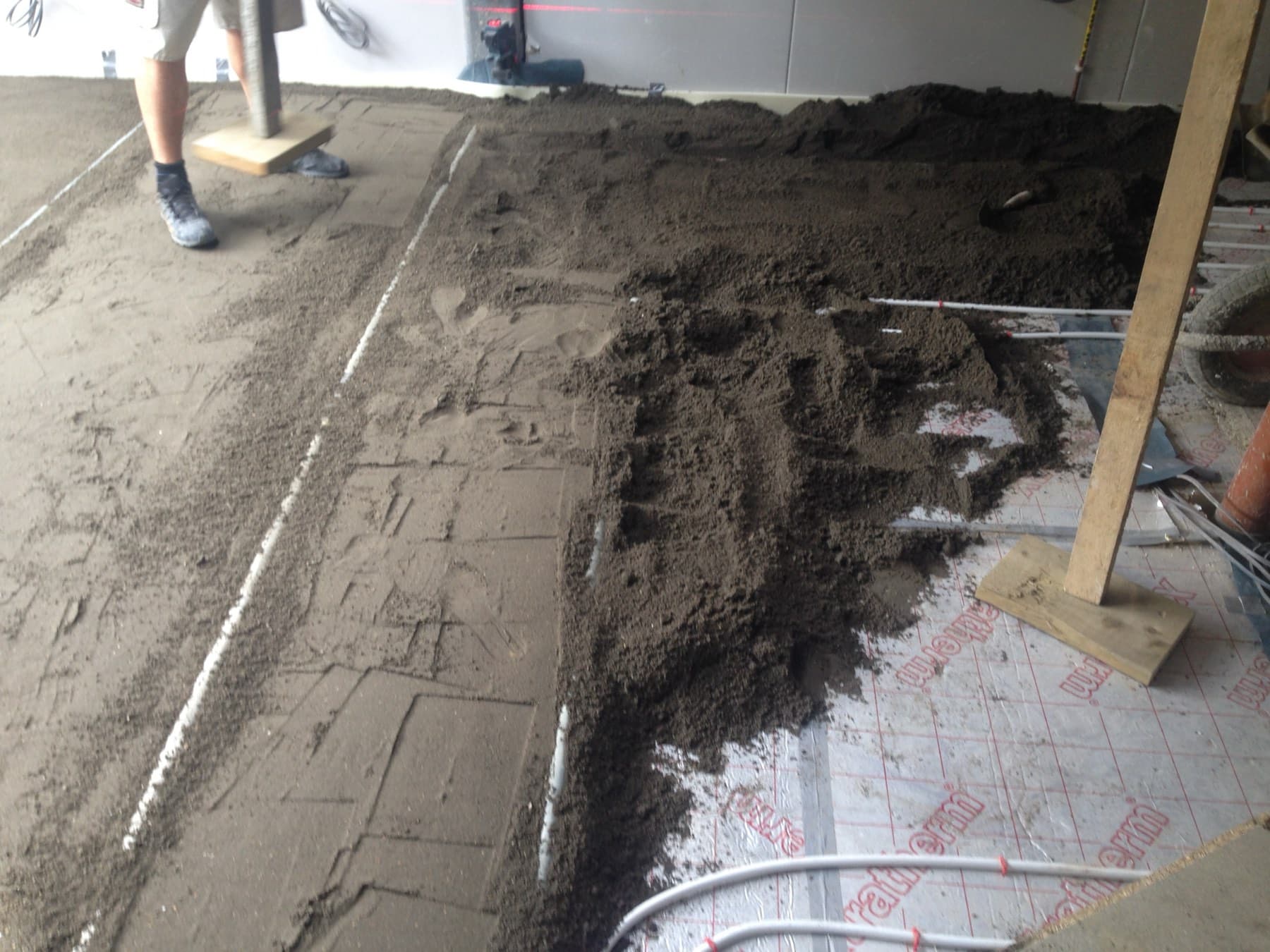 Screed being laid over underfloor heating pipe