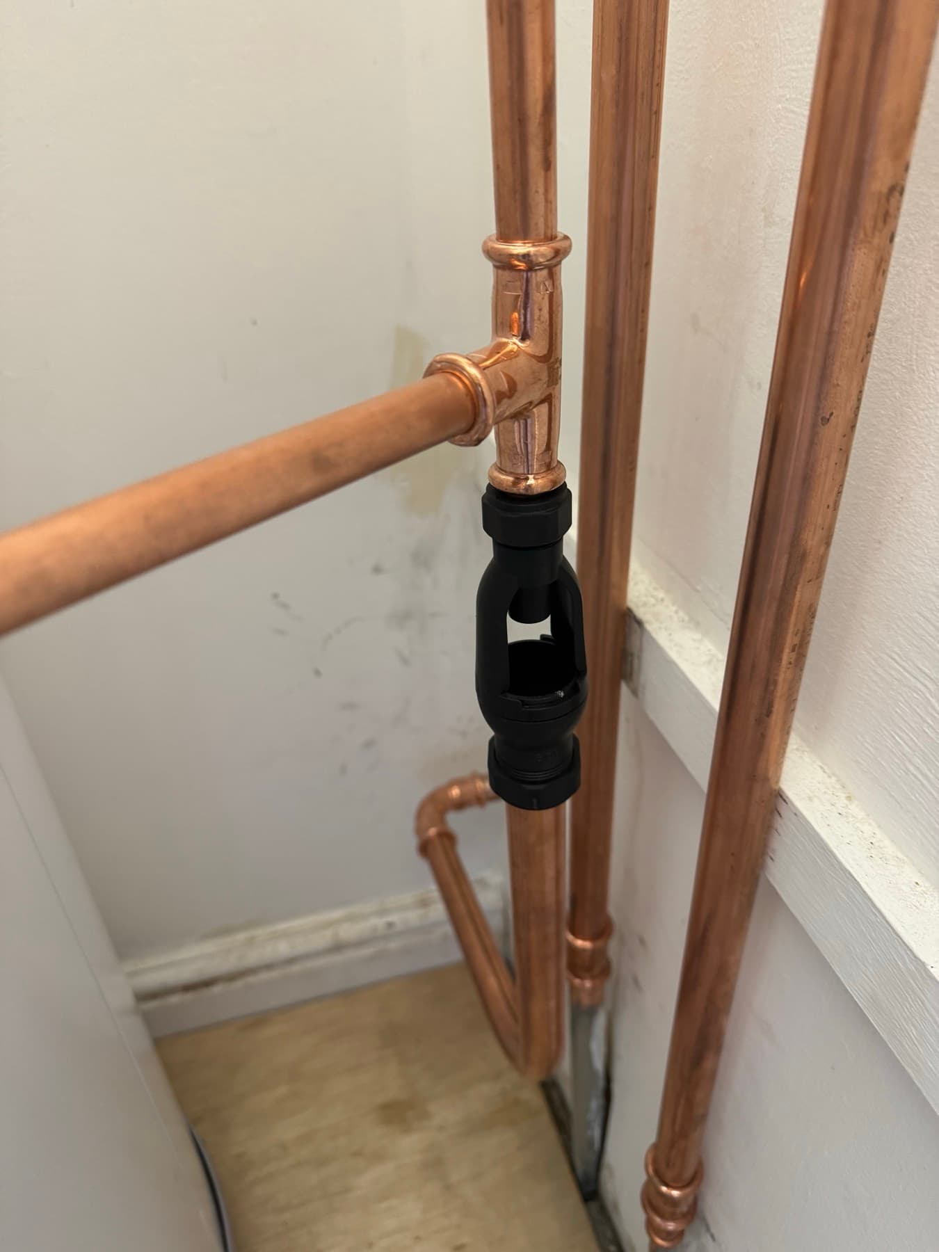 Black tundish on the copper discharge pipe from an unvented cylinder