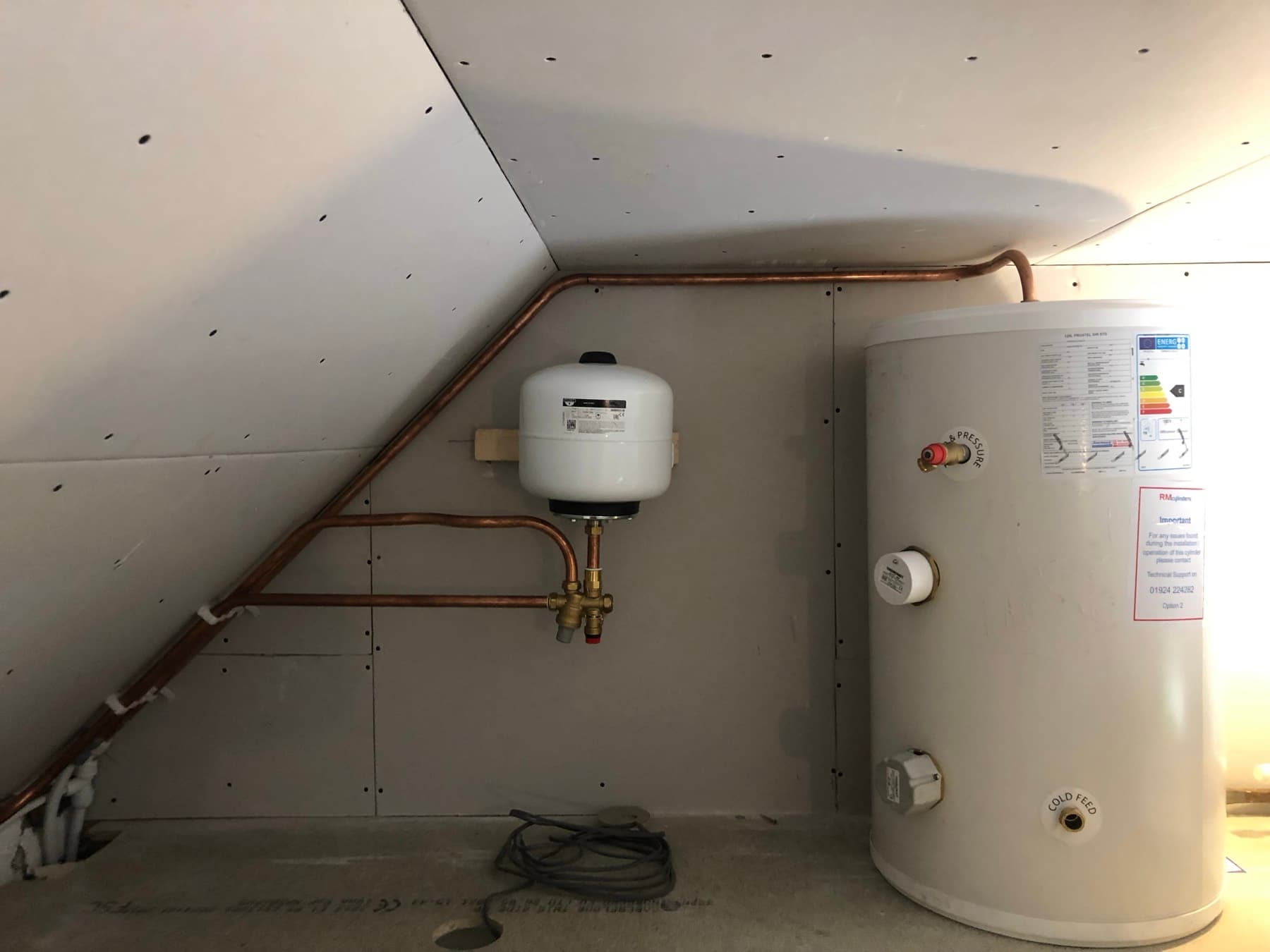 Unvented cylinder and expansion vessel fitted in a loft room with new copper pipework