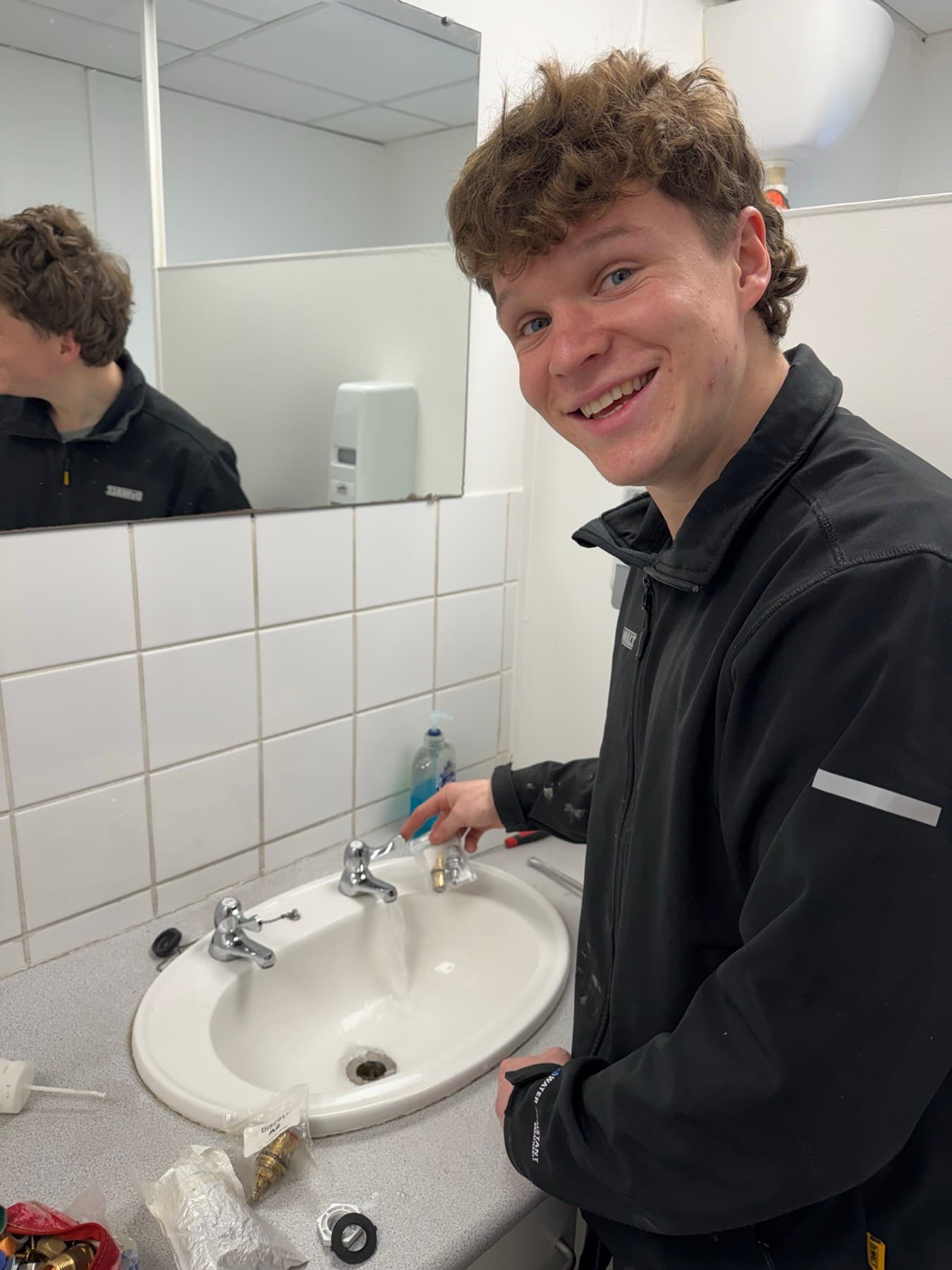 Harry, the Rosebourne apprentice, fitting a basin