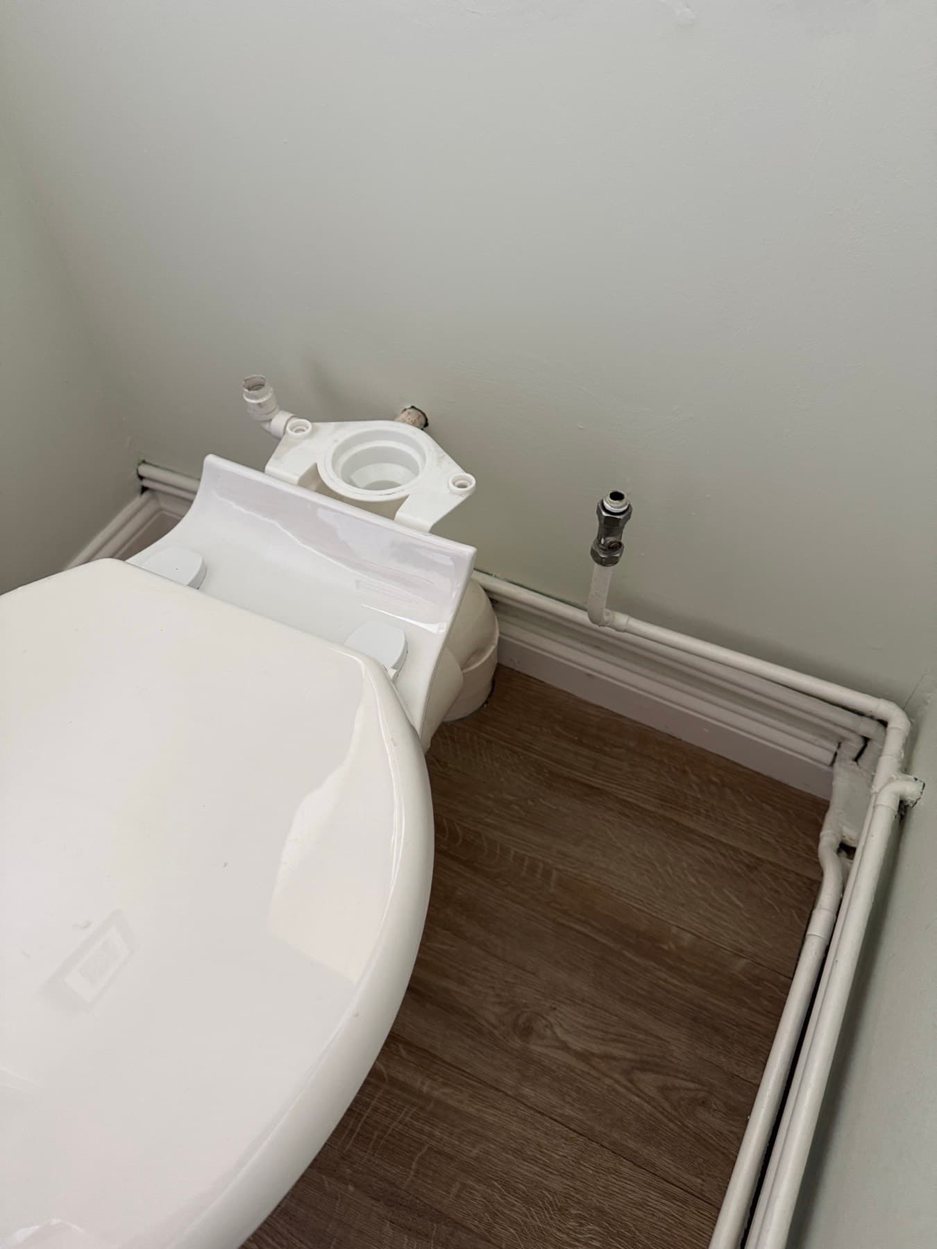 Toilet pan with the cistern removed, copper cold feed with a chrome service valve lined up for the new cistern