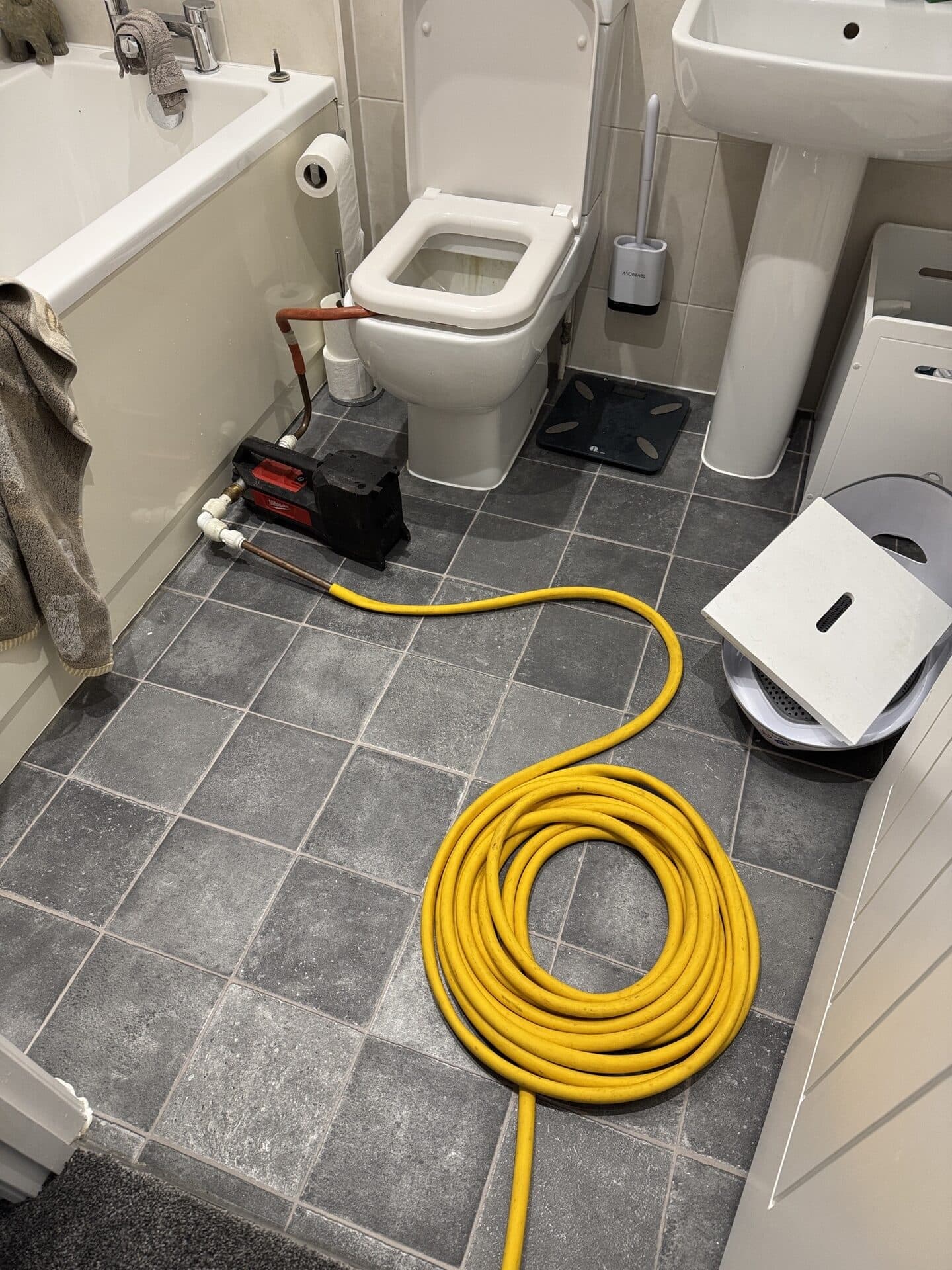 Draining an unvented hot water cylinder down through a hose and pump into the WC during a service