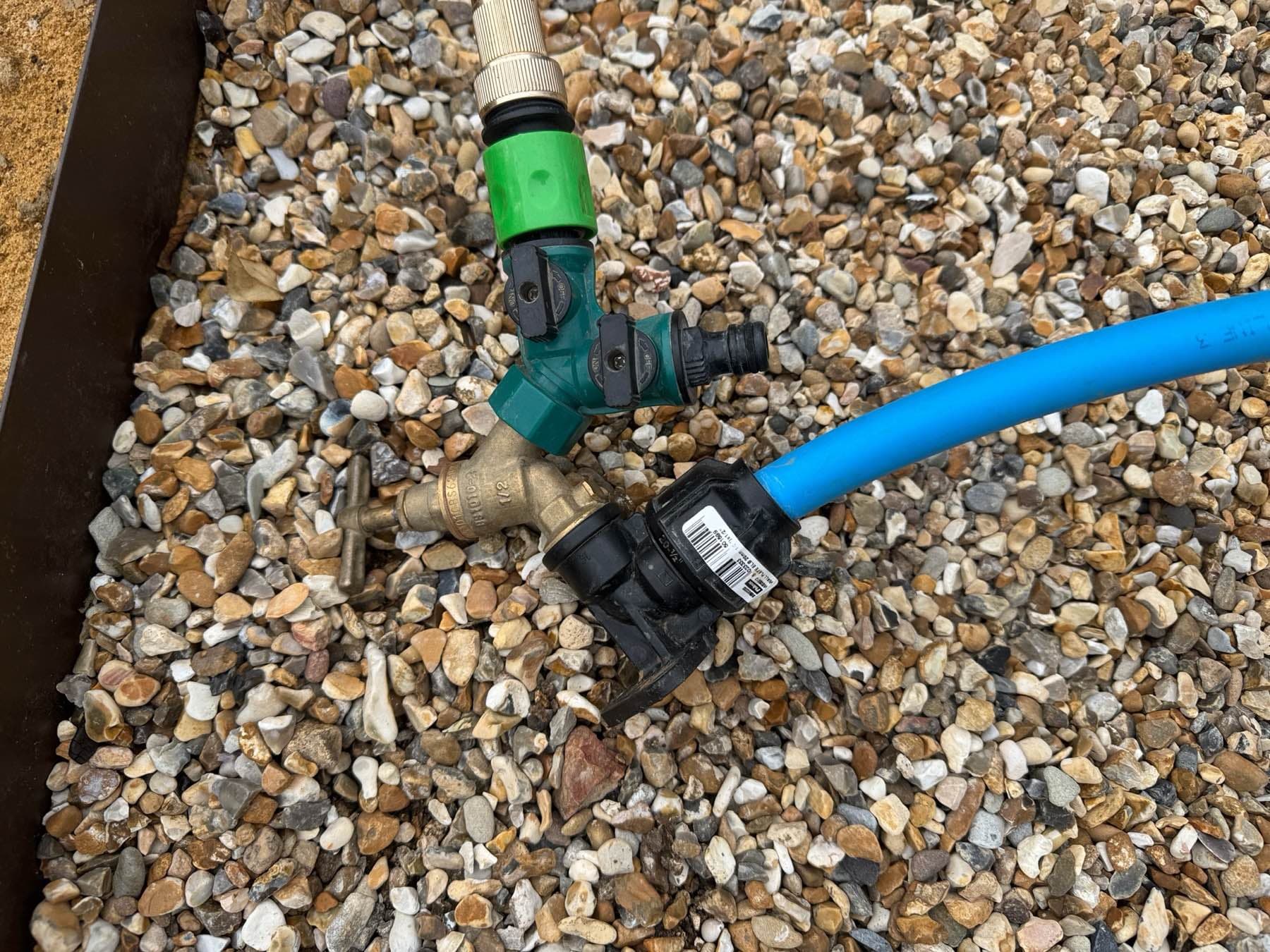 Brass garden tap on a standpipe fed by blue MDPE pipe, fitted by Rosebourne Plumbing