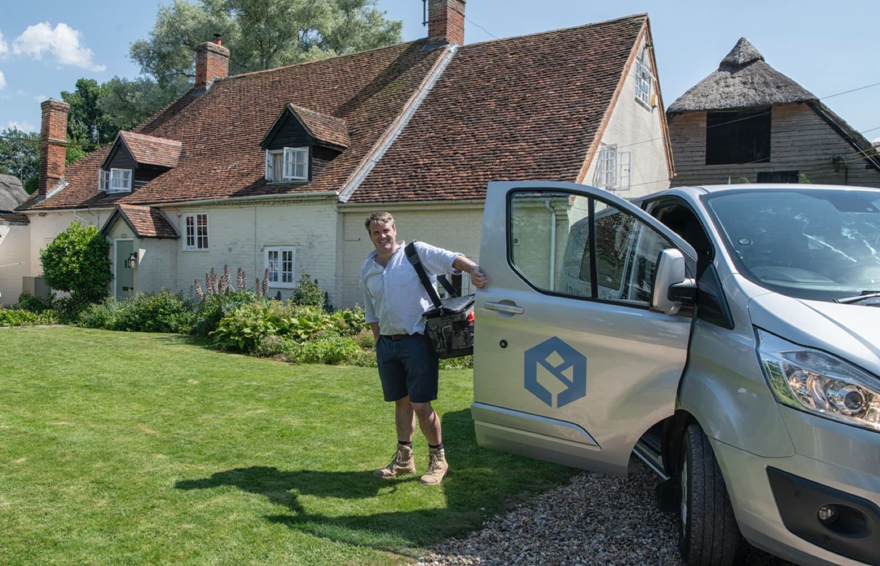 Will Gaze with the Rosebourne Plumbing van outside a thatched cottage