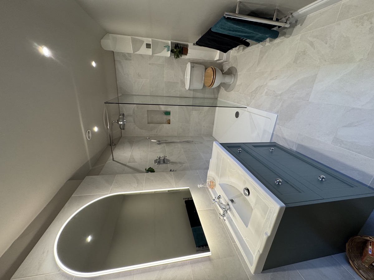 Completed luxury bathroom renovation showcasing modern shower room with professional plumbing installation