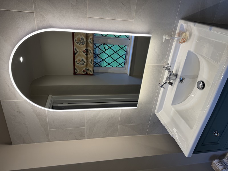 Bathroom basin installation with backlit mirror