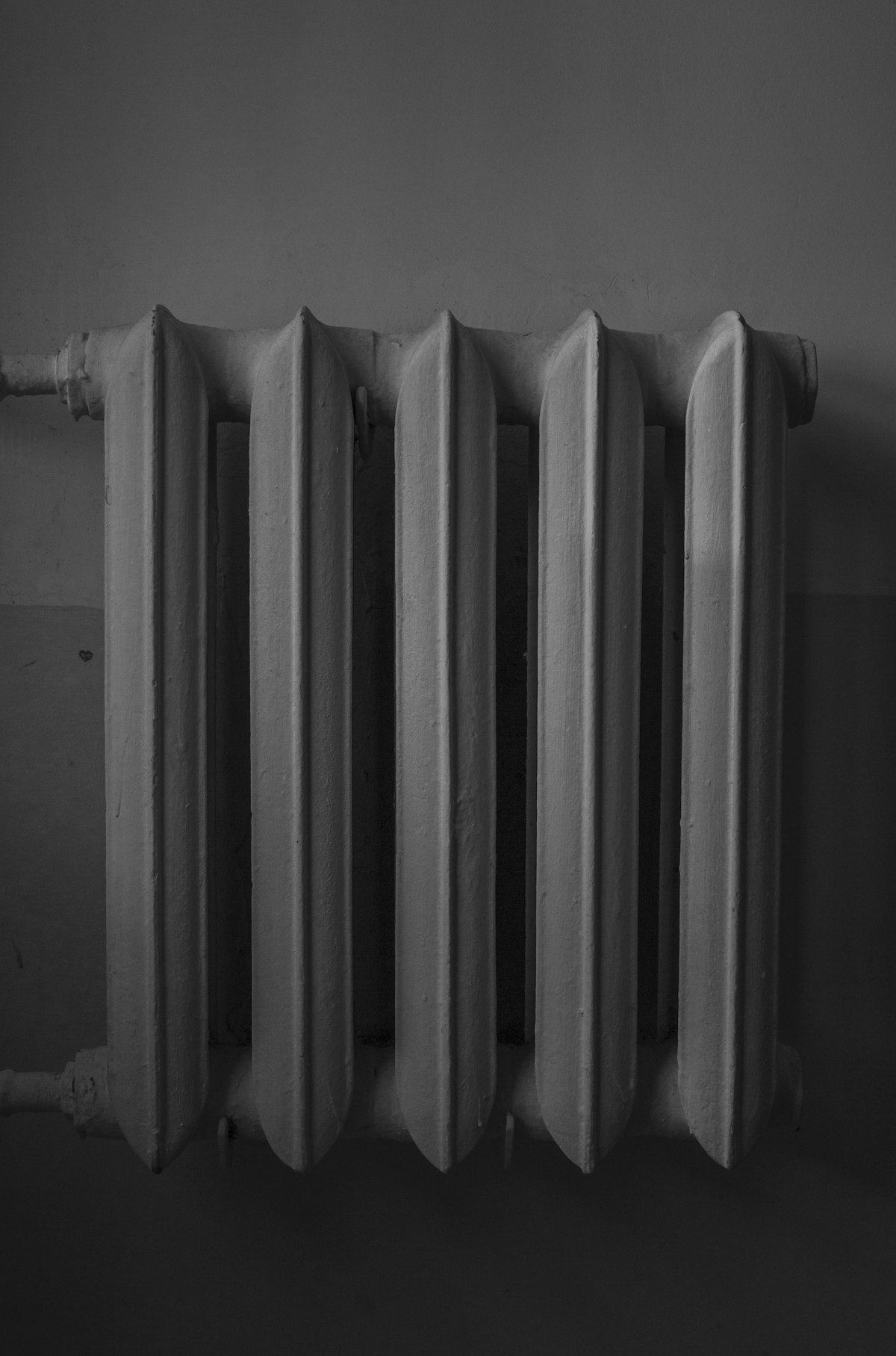 Modern white radiator that may develop cold spots